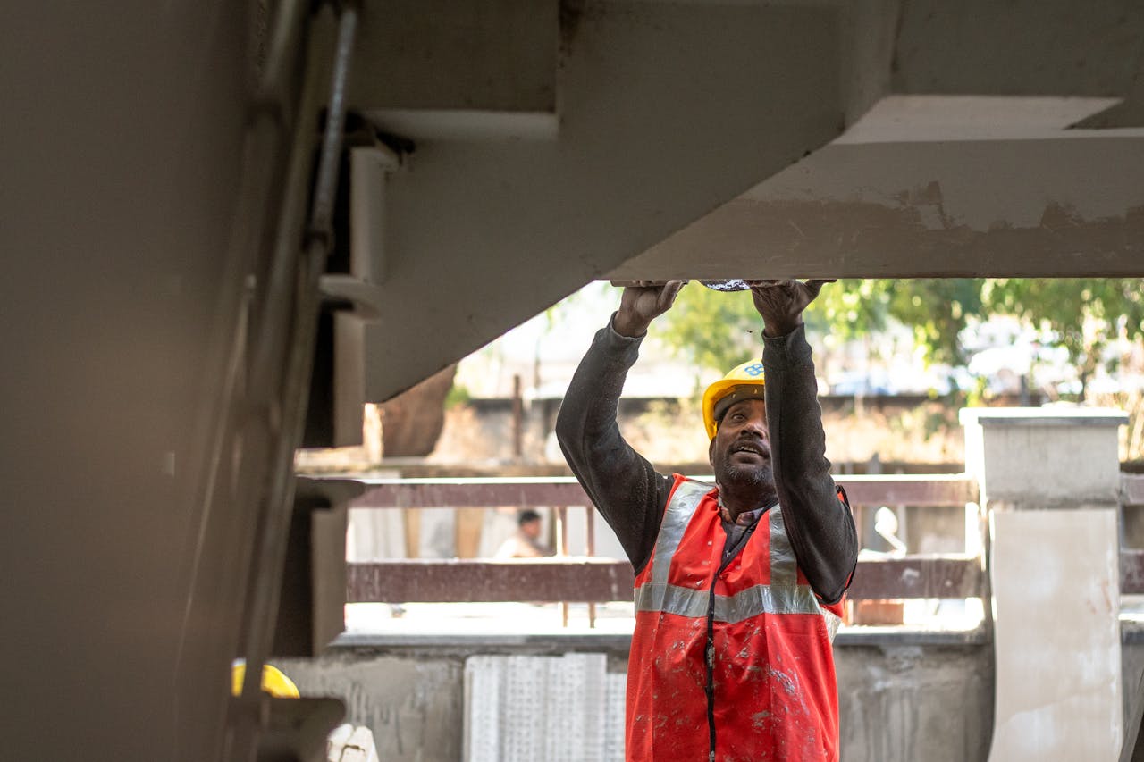 gallery-03 A construction worker inspects a building structure outdoors in Delhi, India.
